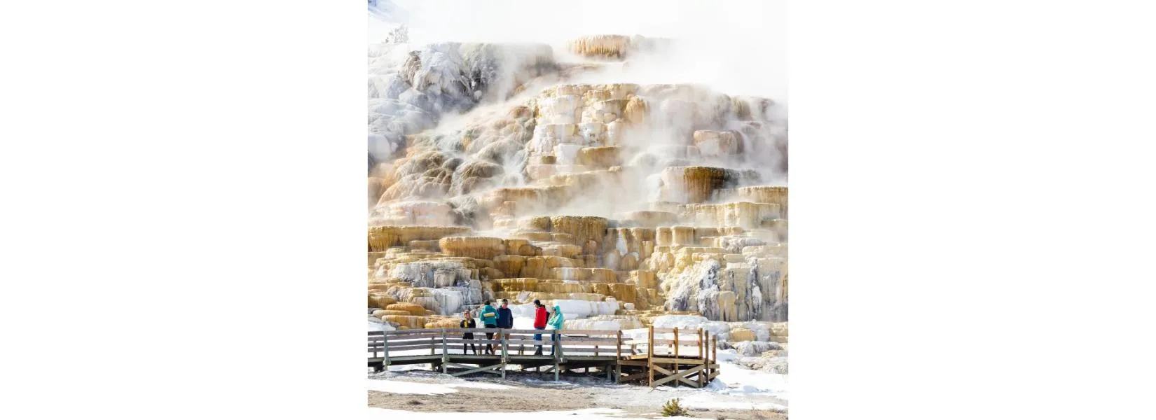 Visitors viewing hot springs from boardwalk safety in Yellowstone National Park